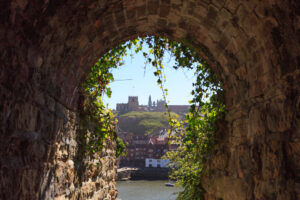 England, North Yorkshire, Whitby. North Sea, East cliff. English Heritage site, ruins of Benedictine abbey, Whitby Abbey, monastery. Inpiration for Caedmon, early English poet and Bram Stoker's gothic tale, Dracula